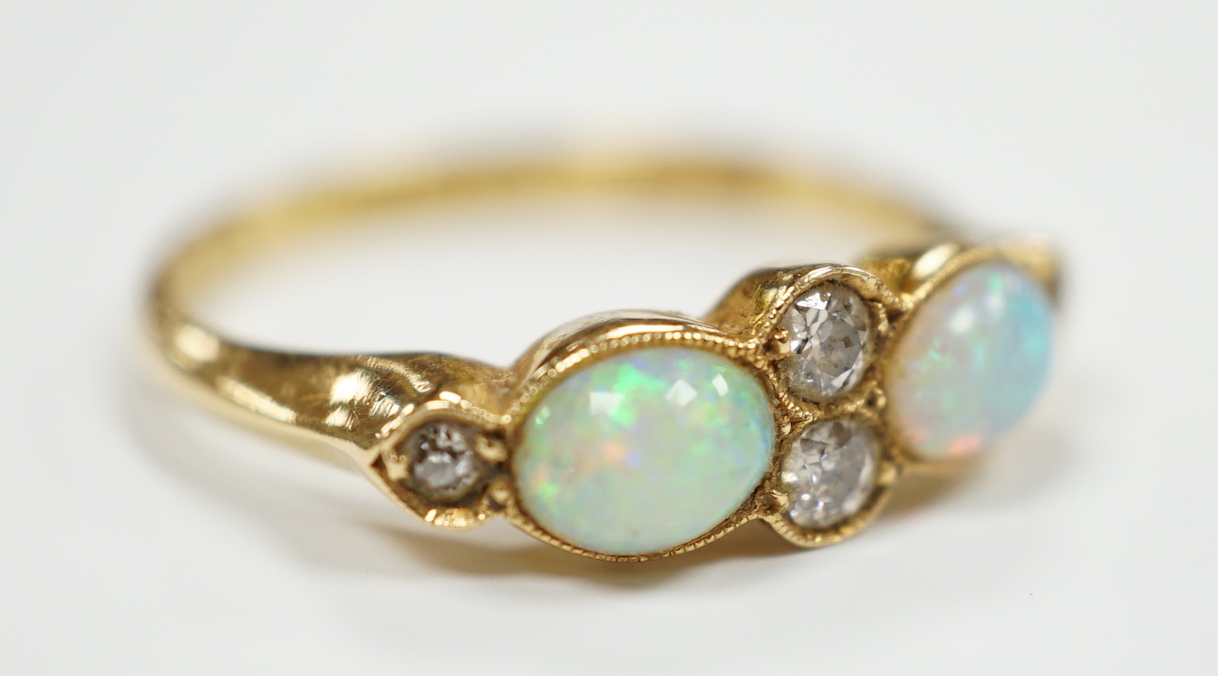 A George V 18ct gold, two stone white opal and four stone diamond chip set half hoop ring, Birmingham, 1917, size P, gross weight 3.6 grams.